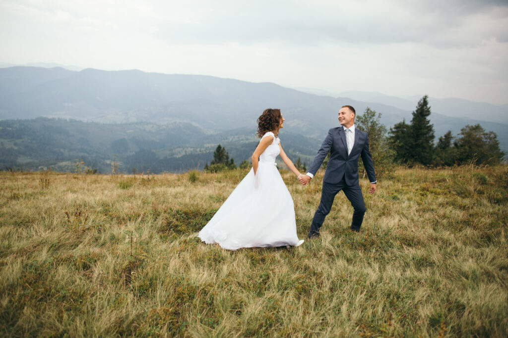 Bride and groom pose for wedding videos in the Smoky Mountains.